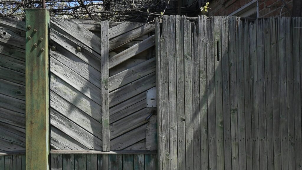 Weathered gray wood fence ready for repair